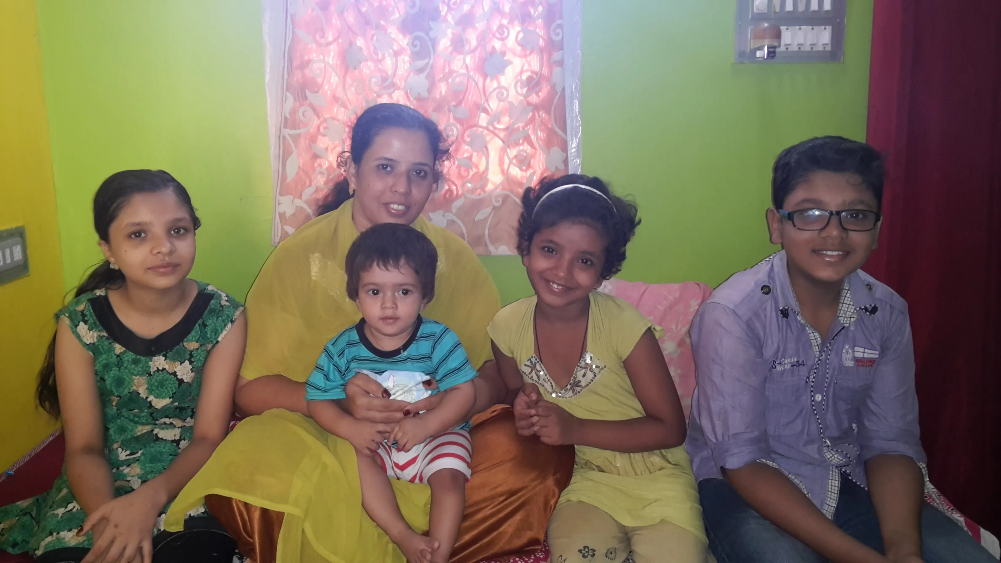 Program lead speaking with a caregiver at a doorway.