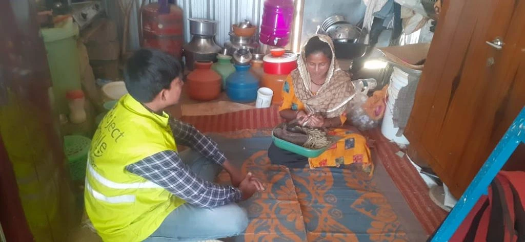 Care team member speaking with a mother in her home.