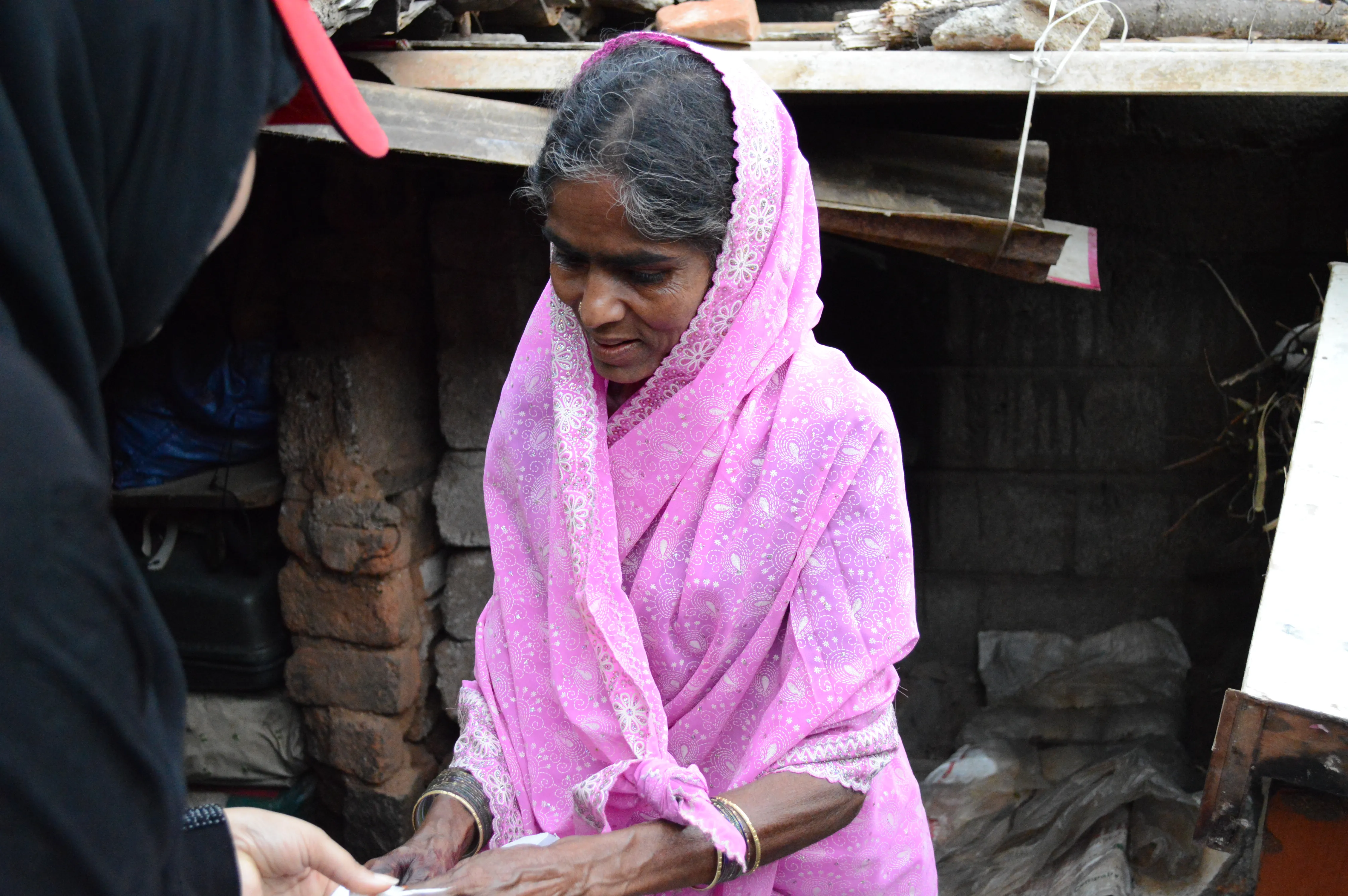 Woman standing at a doorway during a home visit.