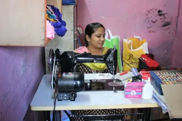 Students holding new books outside a school.